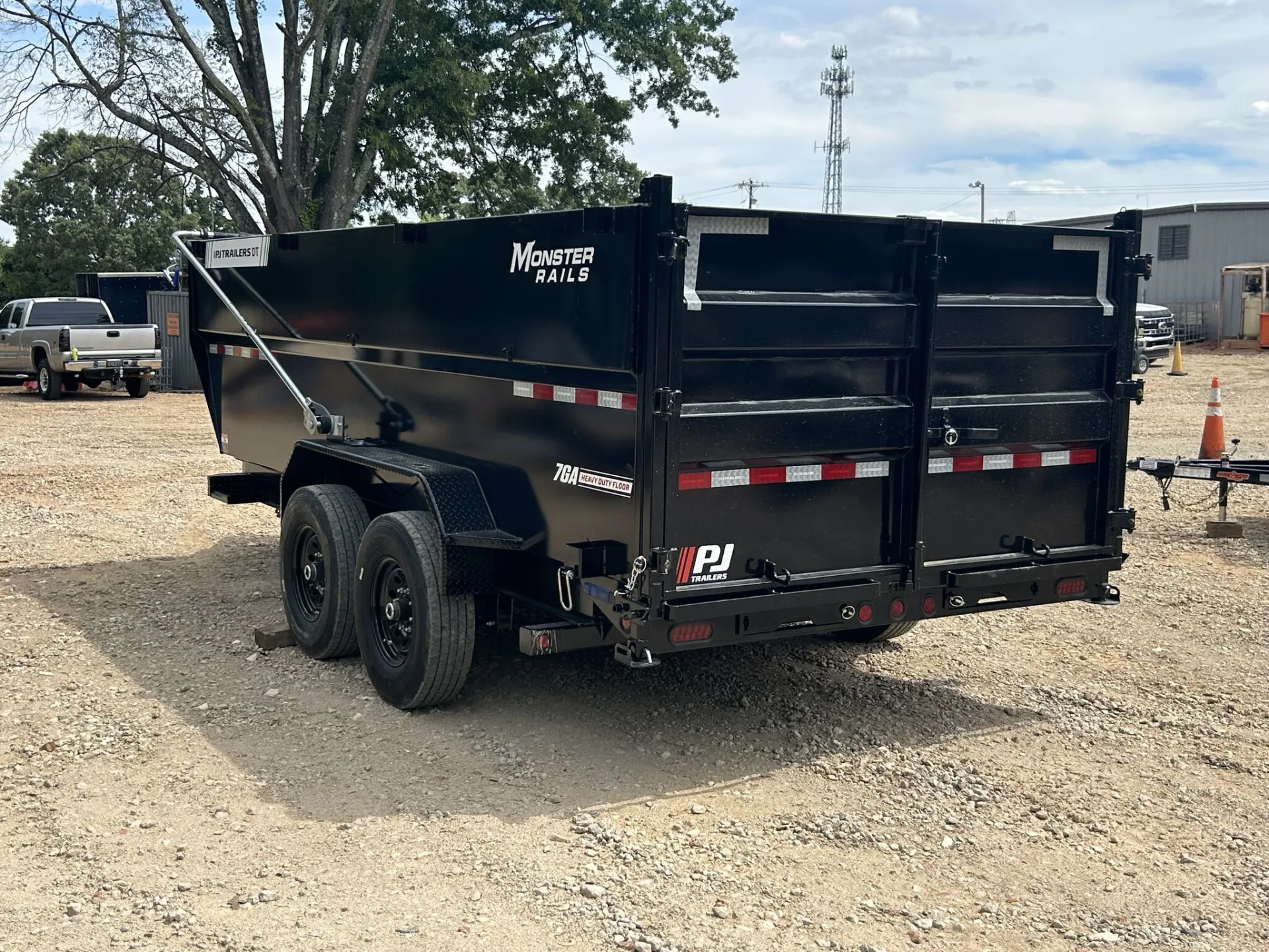 A tandem-axle PJ dump trailer on the lot; axles like these carry the Lippert ID label this guide explains.